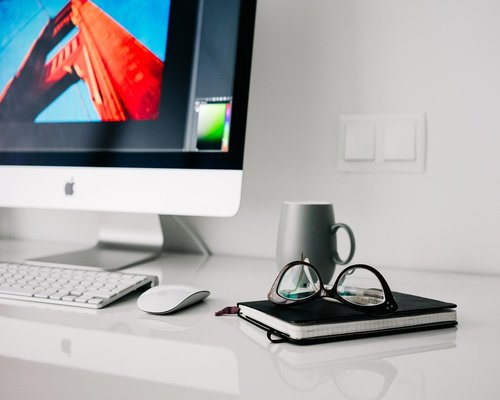 Person doing light stretches next to their home office desk